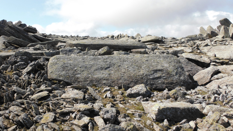  two stone slabs lying away from all the other slabs  