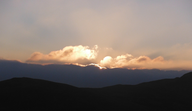  the sun dissappearing behind the big bank of fog 