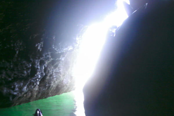 inside the narrow cave looking out