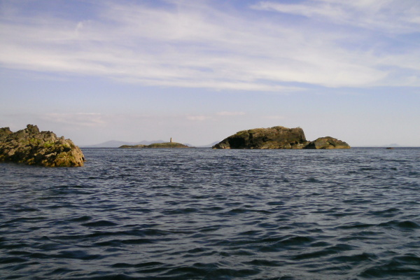 photograph looking past the islands to Rhoscolyn Beacon 