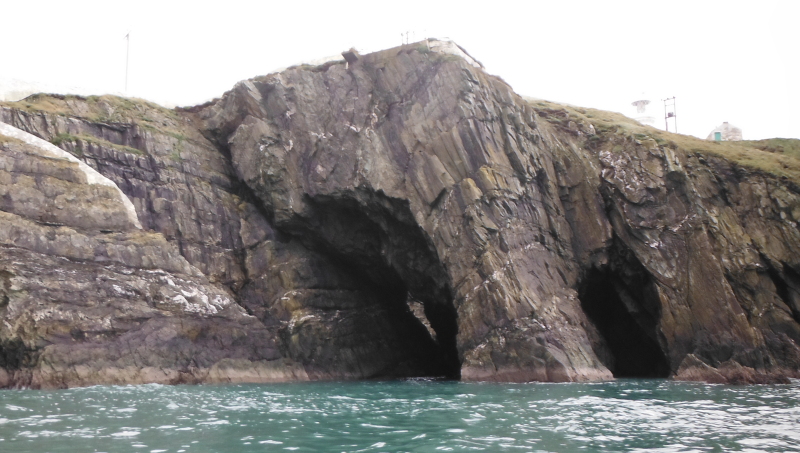 the rocky buttress that separates the two caves  