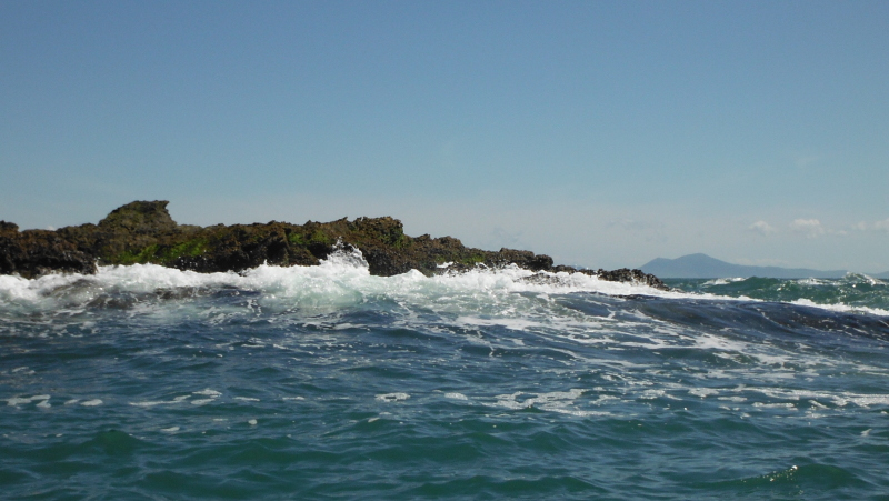  the swell breaking on the last rocks before the outer race  