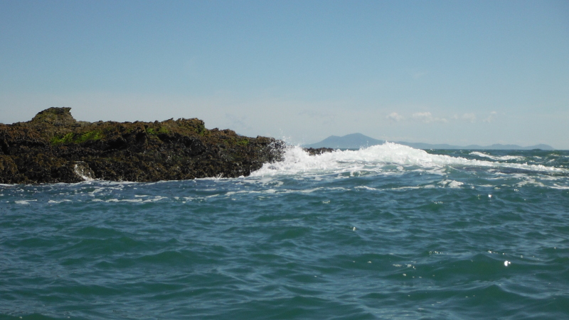  the swell breaking on the last rocks before the outer race  