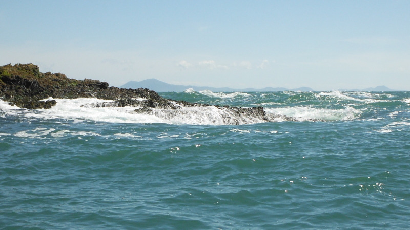  the swell breaking on the last rocks before the outer race  