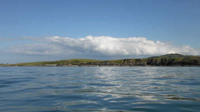  the storm cloud that sat all afternoon over the south end of Anglesey 