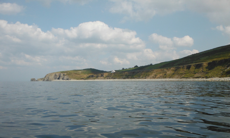  looking back along the stoney beach to Morfa 