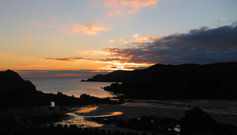 looking across Porth Daffarch to the sunset 