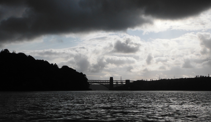  the black cloud overhead, with Britannia Bridge at the back 