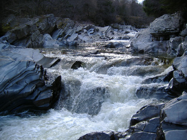 photograph looking up river at the grade 3 - 4 rapid