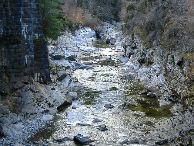 photograph taken from the bridge, looking up upstream