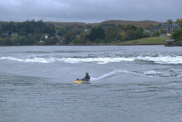 photograph of Colin on the top green wave