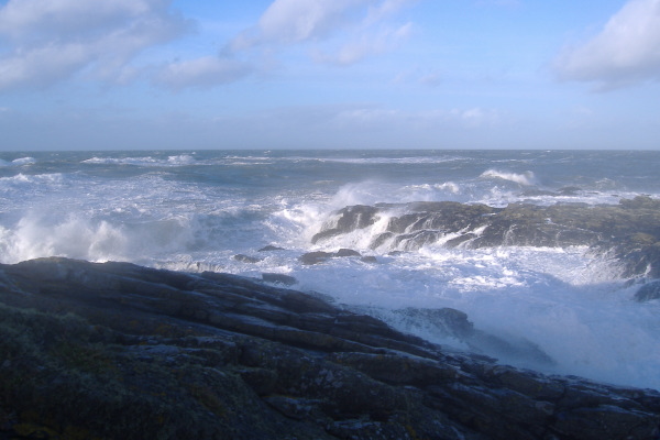 photograph of waves breaking on the point at Cemlyn