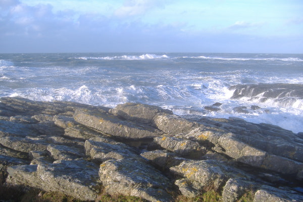 photograph of a big wave breaking over the Harry Furlough`s Rocks