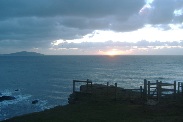 photograph of Holyhead Mountain and the setting sun 