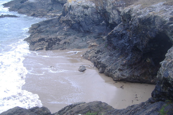 photograph of the sandy beach at the base of the cliffs 