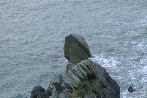 photograph of a rock sitting on a ridge  