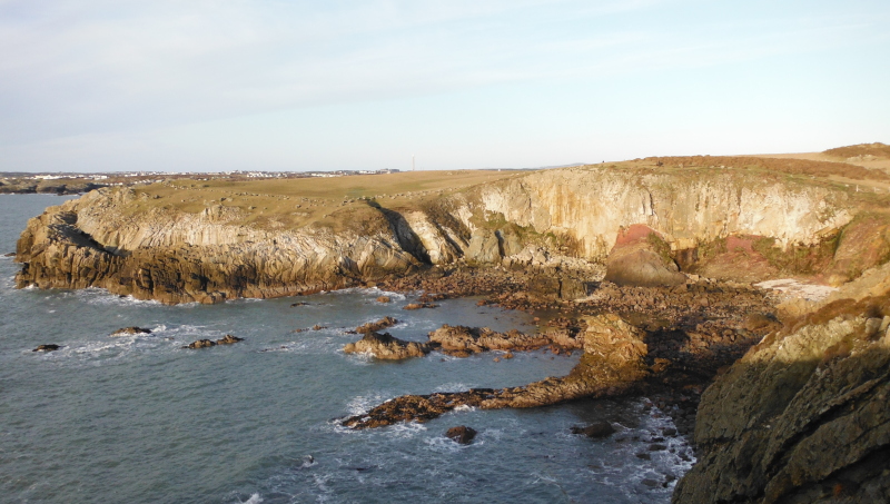 photograph looking across the bay to the headland and its cliffs 