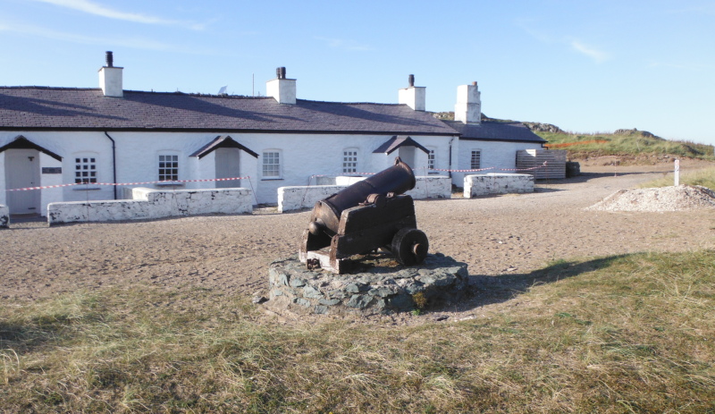  the cannon in front of the cottages