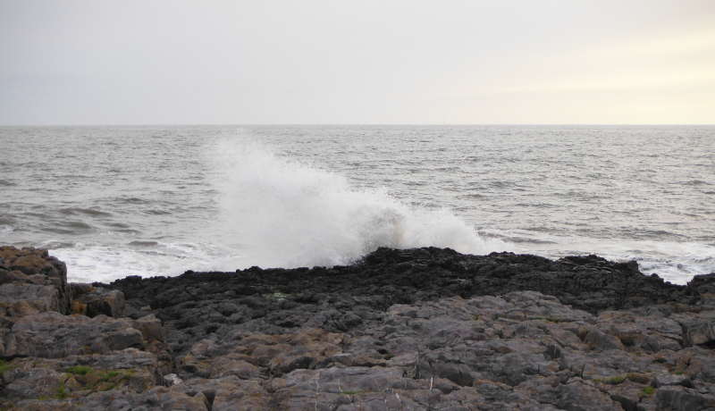  the waves breaking on the rocks 