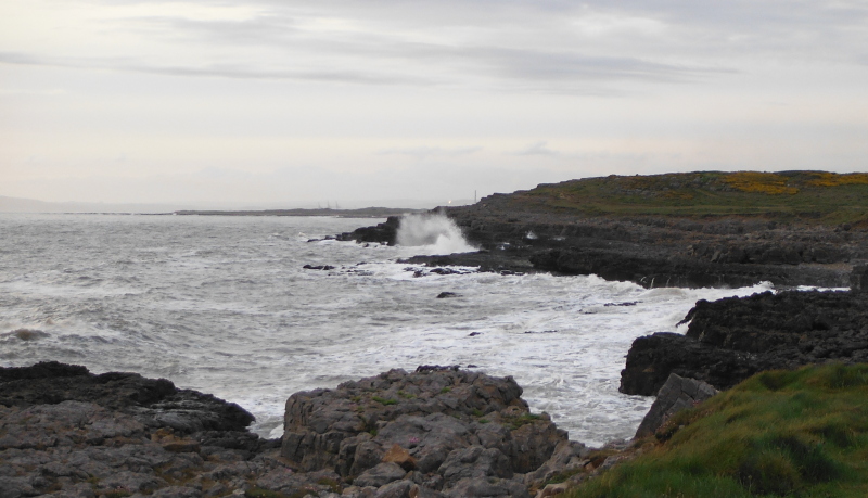  the waves breaking on the rocks 