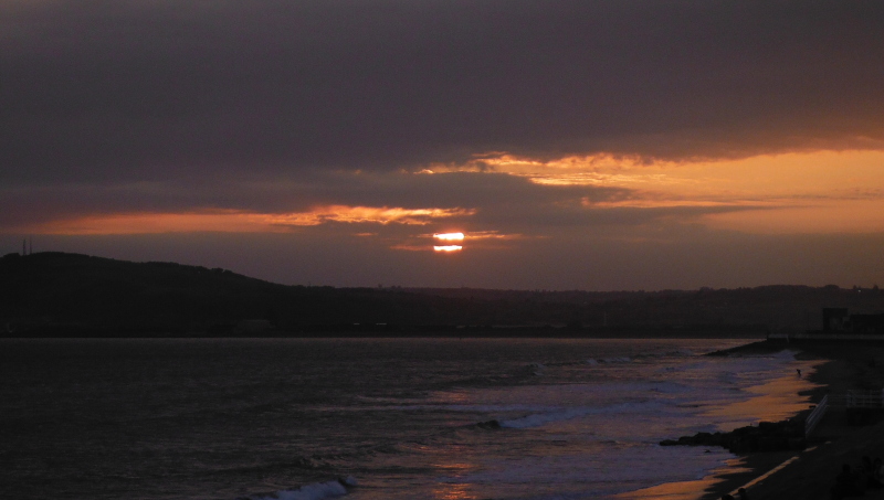  the sun disappearing behind the cloud bank 