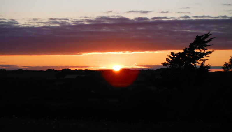  the sun as it drops below the horizon 