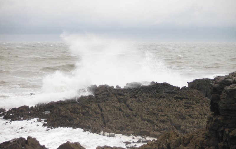  the waves breaking on the rocks 