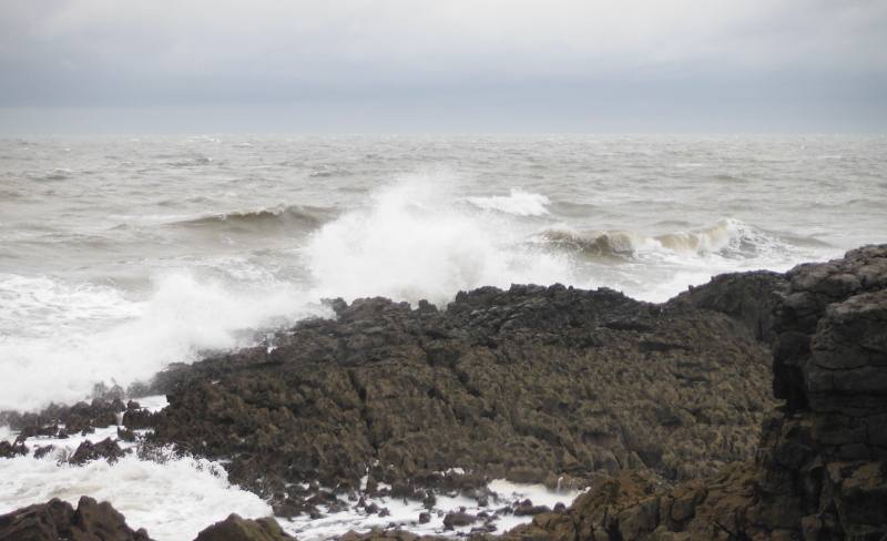  the waves breaking on the rocks 