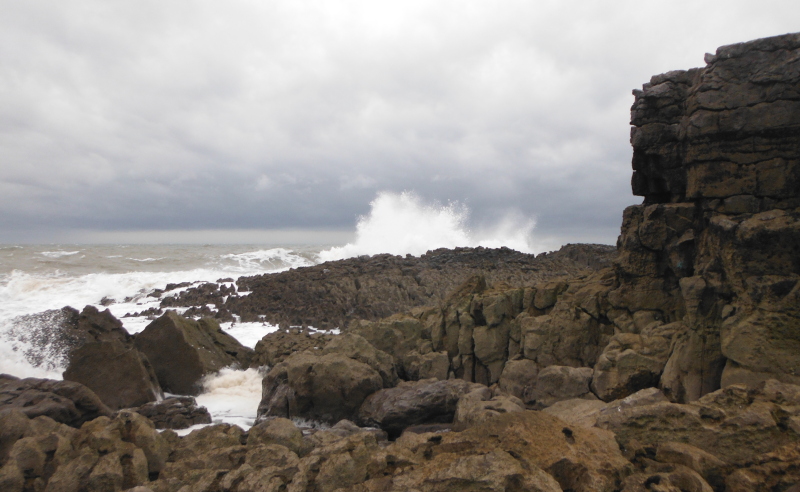  the waves breaking on the rocks 