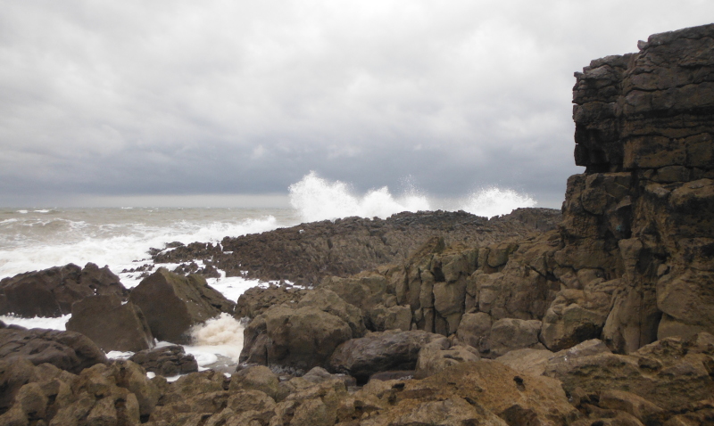  the waves breaking on the rocks 