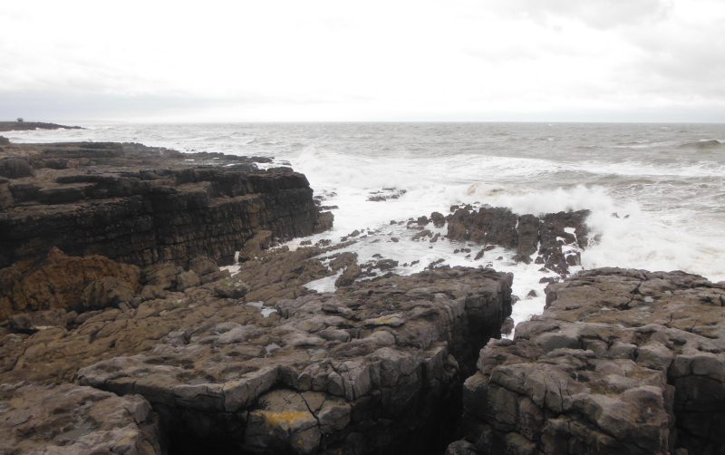  the waves breaking on the rocks 