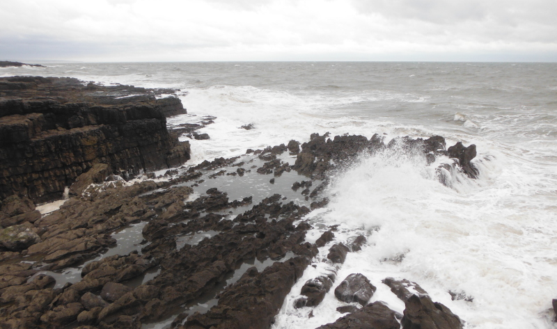  the waves breaking on the rocks 