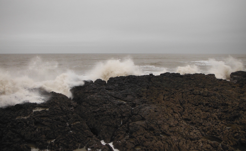  the waves breaking over the rocks 