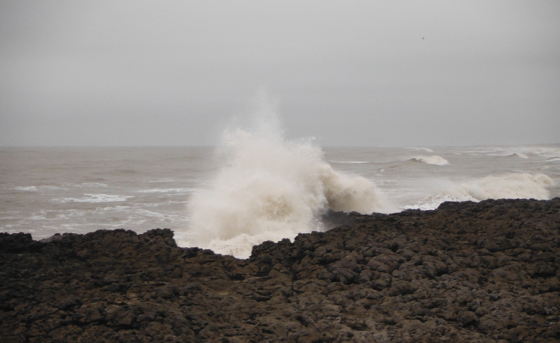  the waves breaking over the rocks 