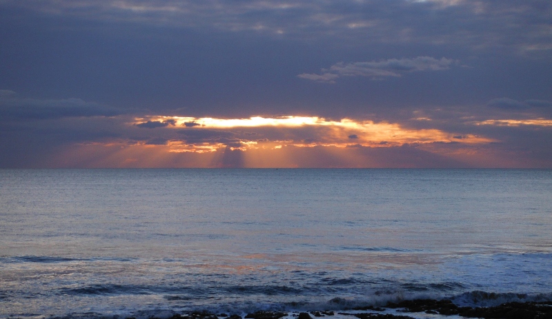  the low angle sun producing shafts of light 