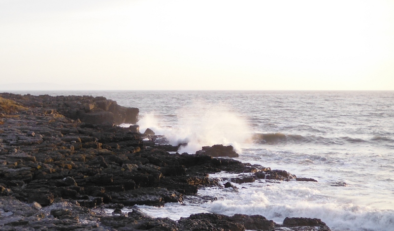  the surf breaking over the rocks 