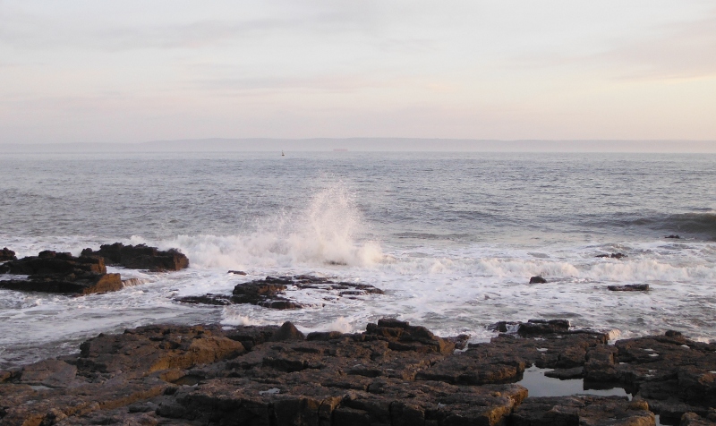  the surf breaking over the rocks 