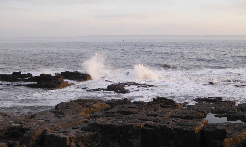  the surf breaking over the rocks 