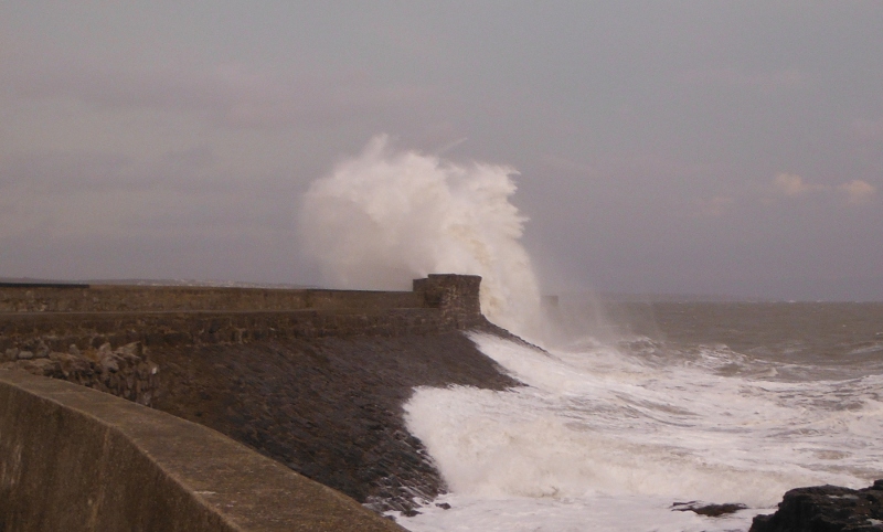  big waves crashing onto the seawall 