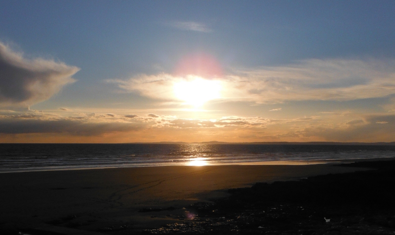  the low sun over Rest Bay and the Gower 