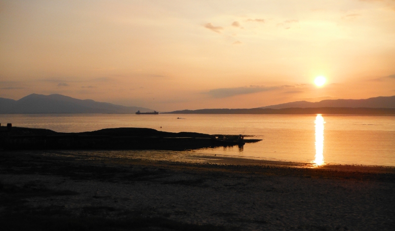  the sun setting over Lismore and Kingairloch 