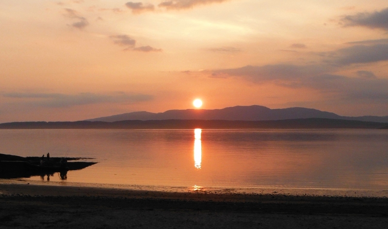  the sun setting over Lismore and Kingairloch 