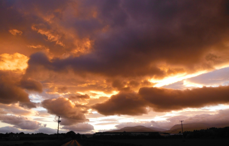  the setting sun lighting up the underneath of the clouds 