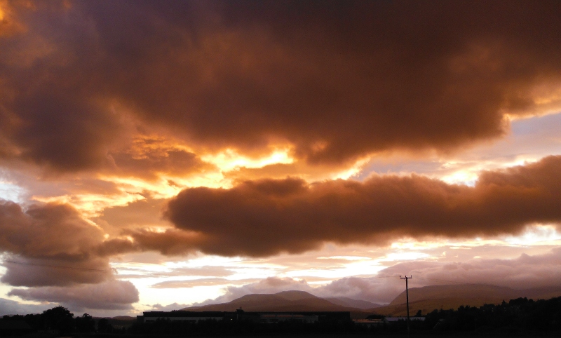  the setting sun lighting up the underneath of the clouds 