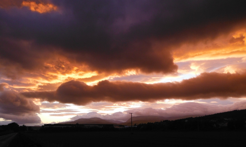  the setting sun lighting up the underneath of the clouds 