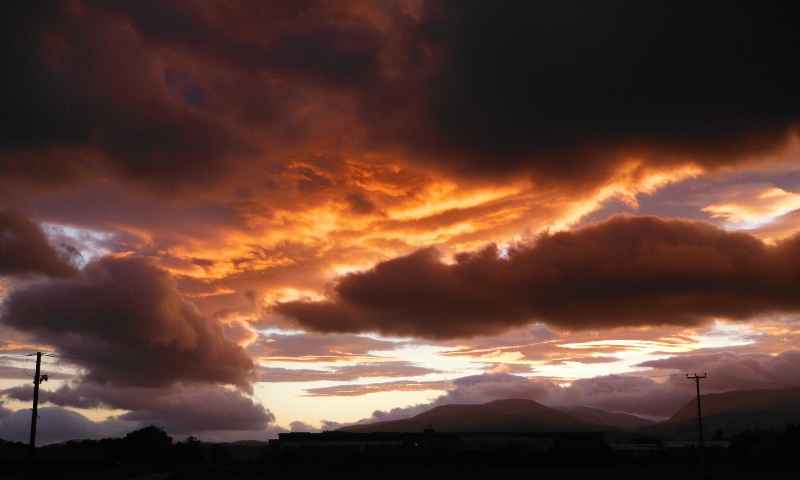  the setting sun lighting up the underneath of the clouds 