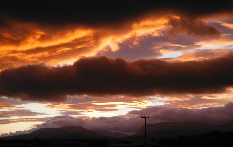  the setting sun lighting up the underneath of the clouds 