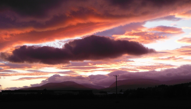  the setting sun lighting up the underneath of the clouds 