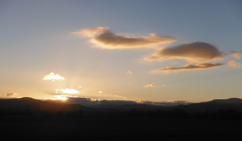  the setting sun lighting up the clouds 