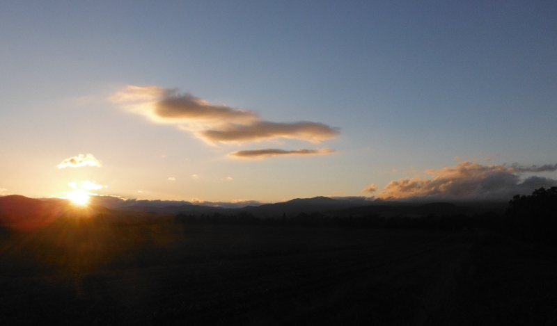  the setting sun lighting up the clouds 